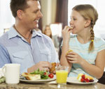 Image Man eating small portions with his daughter