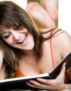 Image of a woman smiling while reading Fame Folder