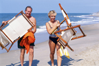 Image of Man and woman putting chairs out on a beach