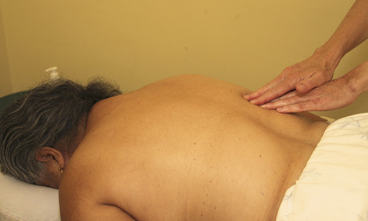 A low-income client of Charlotte Maxwell Clinic in Oakland, California, receives a massage session.