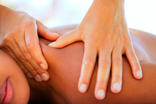 Hands massaging woman
