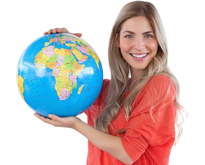 Woman holding a globe on a white background