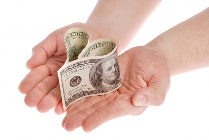 Heart shaped money, on white background. Clipping path included.