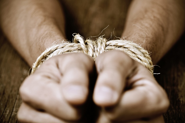 closeup of a young man with a blindfold in his eyes, as a symbol of oppression or repression
