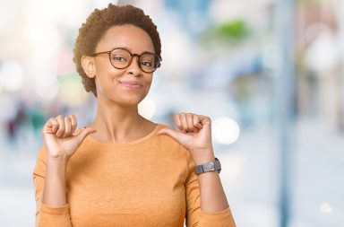 woman, with confident smile, who has a happy work life