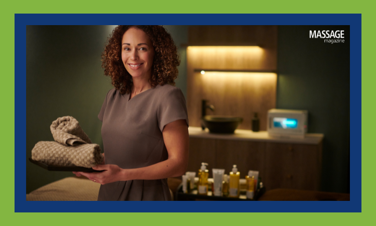 Image for an article about the stages of massage business growth. Image of massage therapist preparing a treatment room. 