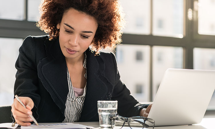 An image of a businesswoman with a computer is used to illustrate the concept of financial reports for small business.
