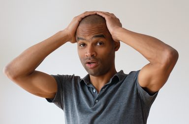 man looking overwhelmed by massage school choices