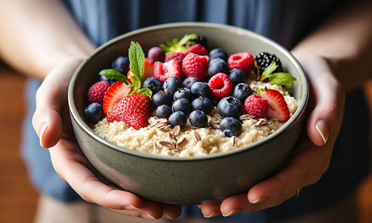 An image of a bowl of oats with fruit is used to illustrate the concept of good carbs (and conversely, bad carbs).