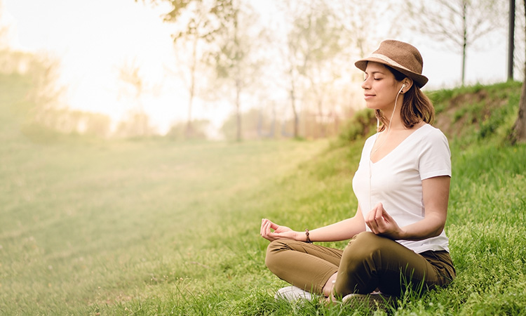A photo of a woman meditating in nature is used to illustrate the concept of guided visualization.