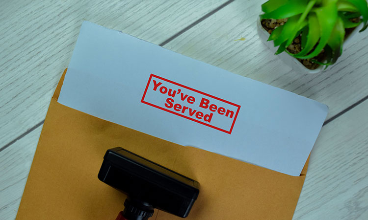 An image of an envelope with the words "You've Been Served" stamped on it is used to illustrate the concept of legal action, which is why massage therapists should invest in liability insurance.