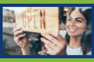 Image for an article about Small Business Administration supporting massage therapists. Image of woman flipping an open sign