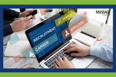 Image for an article about hiring staff for a massage practice. Image of a person using a computer to access potential employees.