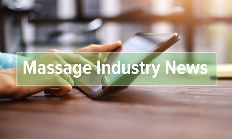 The words Massage Industry News overlaid on an image of hands on an iPad