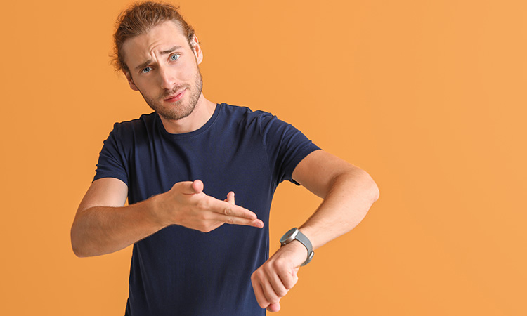 An image of a person pointing at his watch is used to illustrate the concept of "last-minute" appointment cancellations and no-shows.