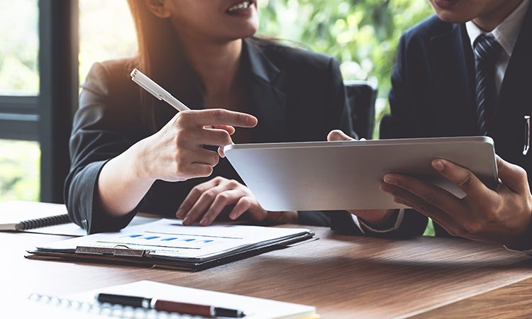 featured image for blog about growing a small business with a business coach. Image of two people in a business setting