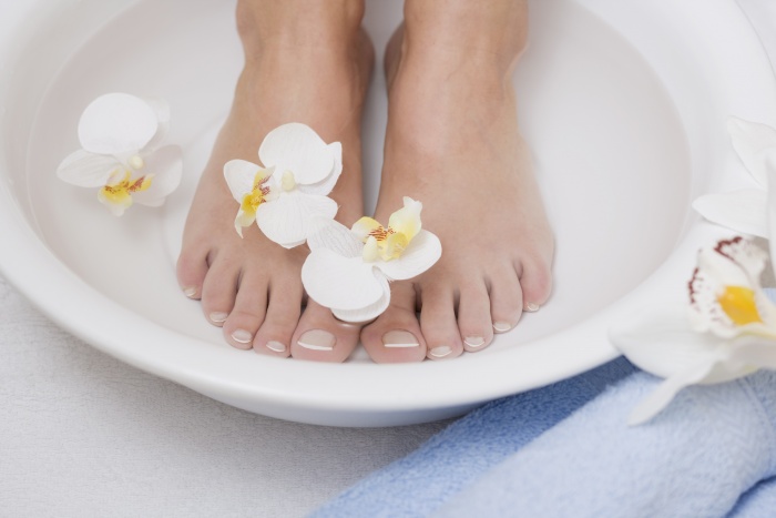 Relaxing foot bath with white orchids