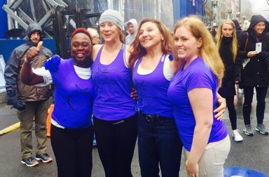 On one of the coldest days in Boston Marathon history, Desiree Van Oosting toed the starting line in a shower cap. She is one of the four runners who ran under a charity bib for the Massage Therapy Foundation to raise money for research.
