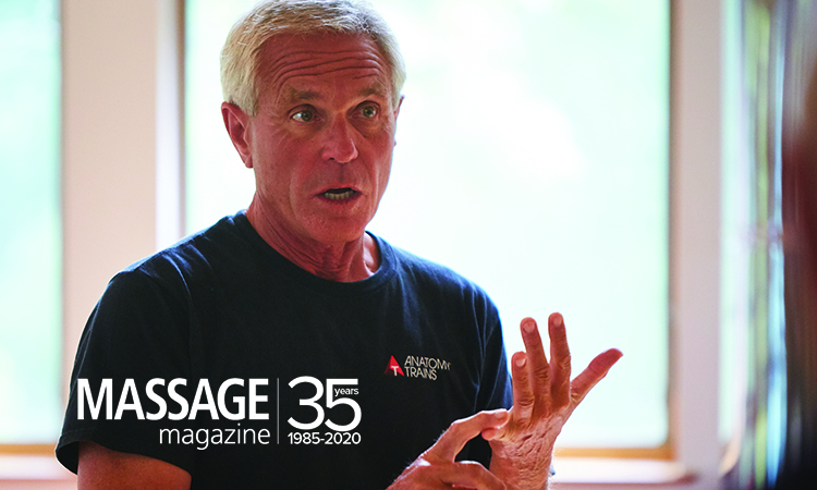 Author Thomas Myers gestures with his hands while talking about fascia. A banner stating "Massage Magazine 35 - 1985-2020 is superimposed over the bottom of the photo.