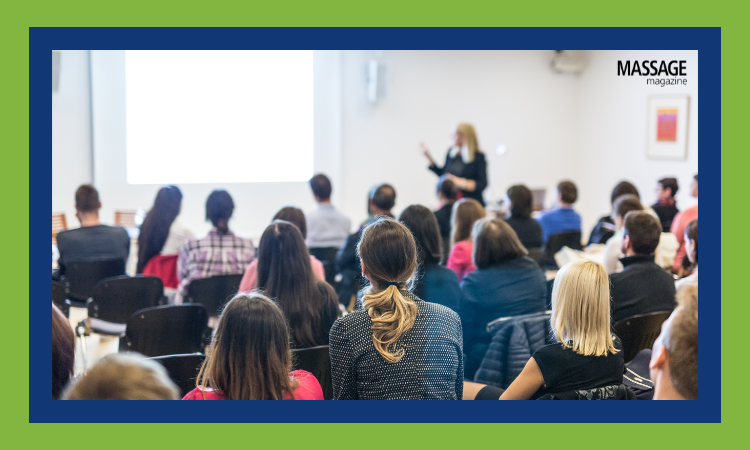 Image for an article about hosting community events to boost outreach. Image of an audience attending a public presentation.