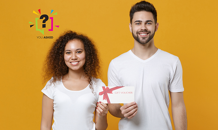 Smiling young couple two friends european guy african american girl in white t-shirts posing isolated on yellow background studio to illustrate massage supplemental income.