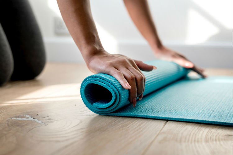 A woman about to start practicing yoga routines for massage therapists